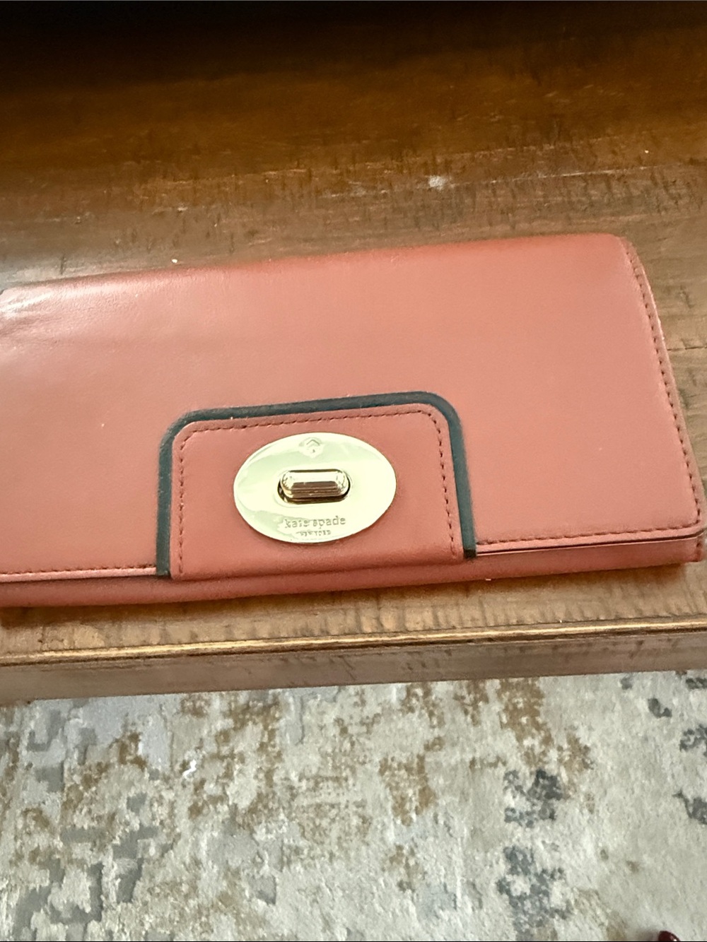 kate spade rust  leather wallet with gold  turn lock and black trim